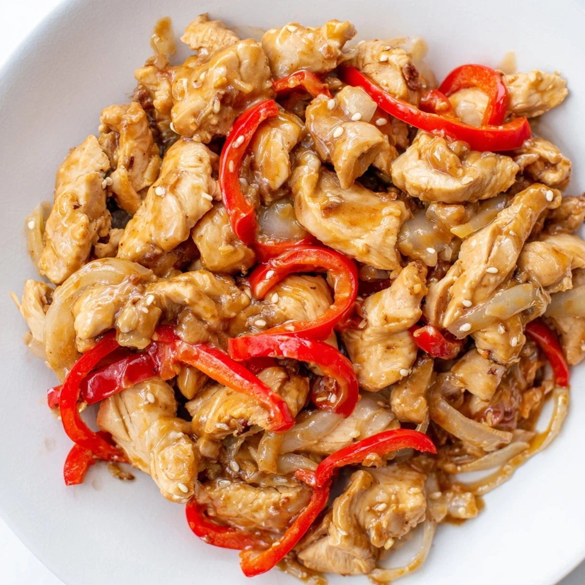 Savory slow cooker peanut chicken served over steamed jasmine rice and garnished with chopped roasted peanuts and fresh cilantro