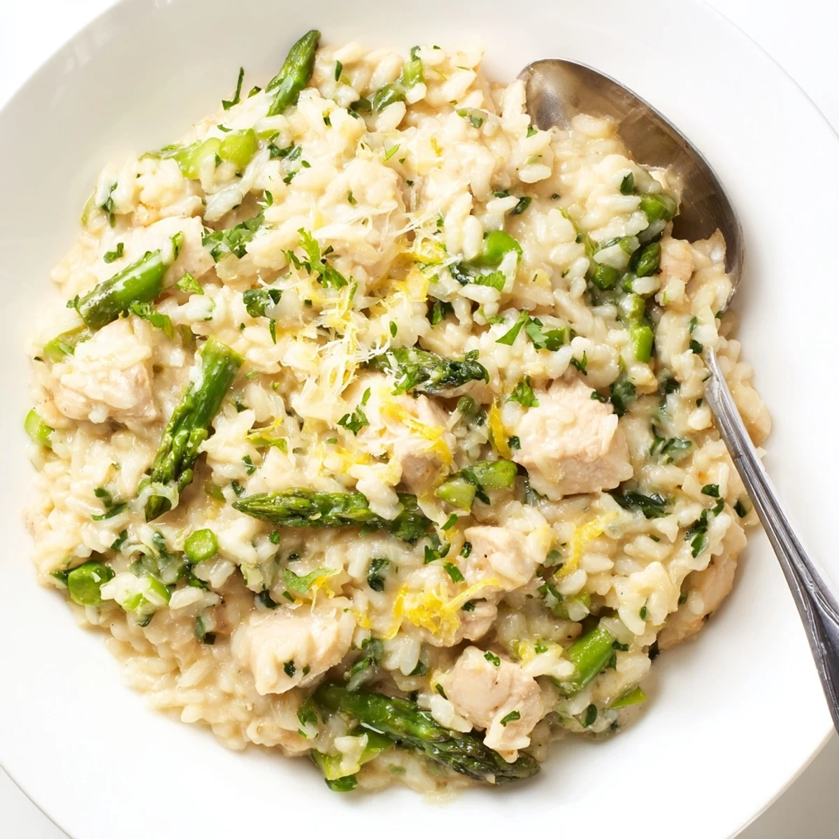 Creamy chicken and asparagus risotto topped with freshly grated Parmesan and parsley.