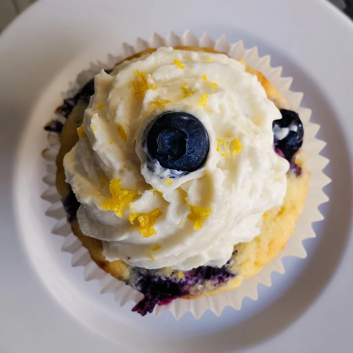 Golden homemade lemon blueberry cupcakes bursting with juicy berries and zesty lemon cream cheese frosting