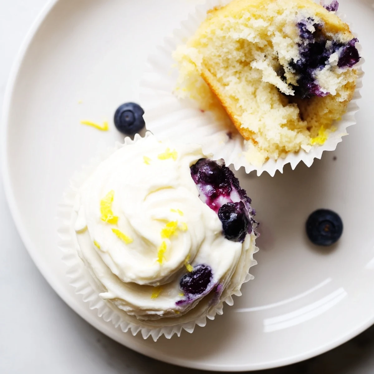 Light and airy lemon blueberry cupcakes with smooth lemon frosting and fresh blueberry garnish
