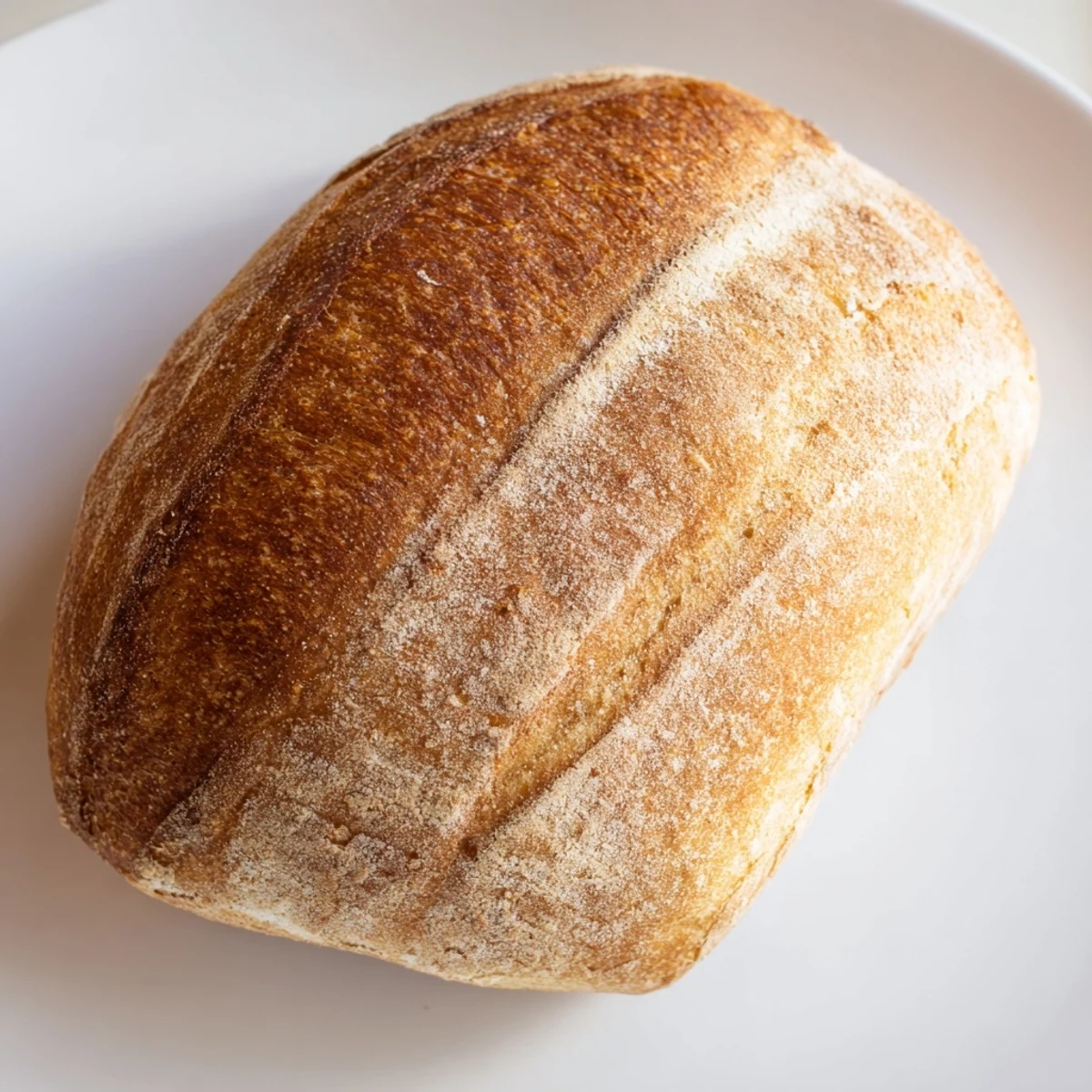 Golden crusty Italian bread loaf with deep brown scoring and soft interior perfect for dipping