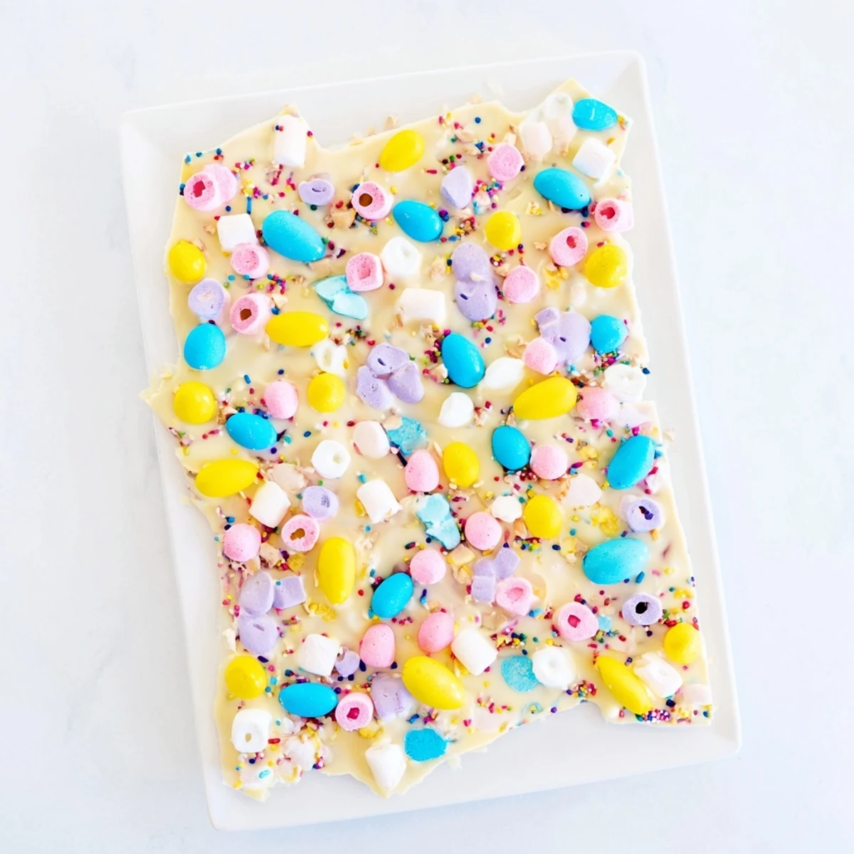 Festive Easter Marshmallow Bark with pastel marshmallows and white chocolate scattered with candy eggs