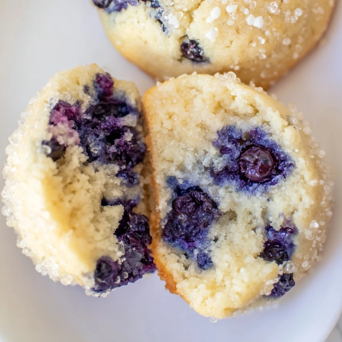 Soft blueberry muffin cookies with golden edges studded with juicy fresh berries on rustic parchment paper