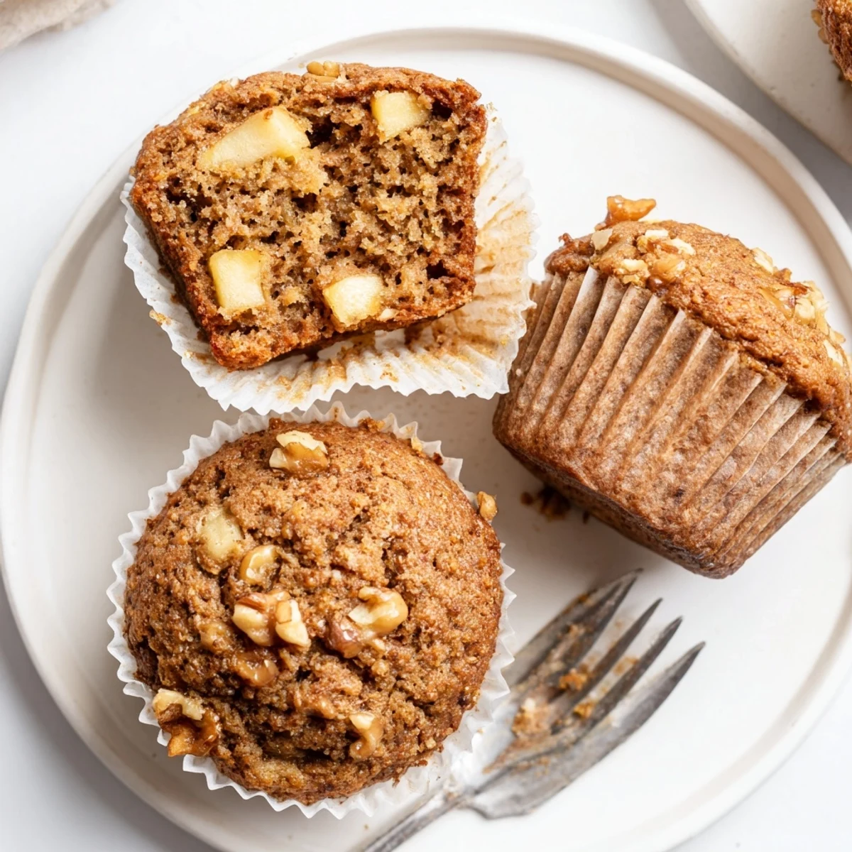 Warm Healthy Apple Cinnamon Greek Yogurt Muffins topped with cinnamon sugar and walnuts