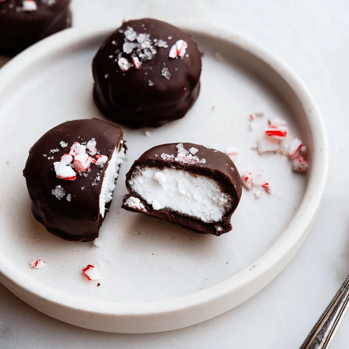 Homemade Peppermint Patties chilled, creamy center contrasted with firm chocolate exterior