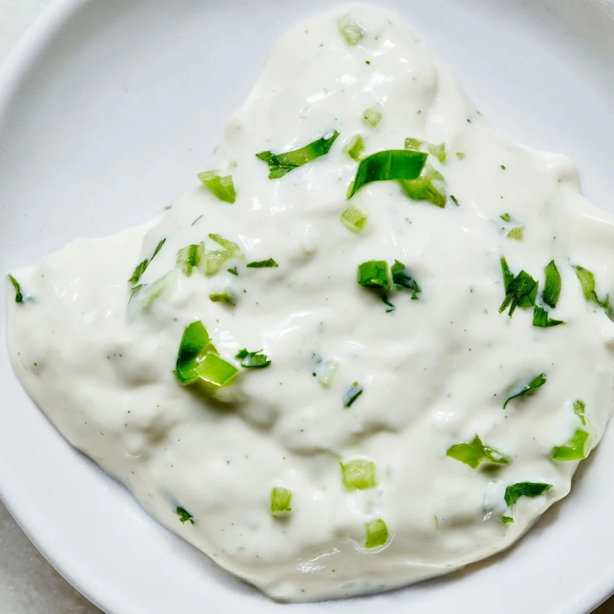 Rich and tangy Mexican white sauce drizzled over crispy golden tacos and grilled seasoned chicken