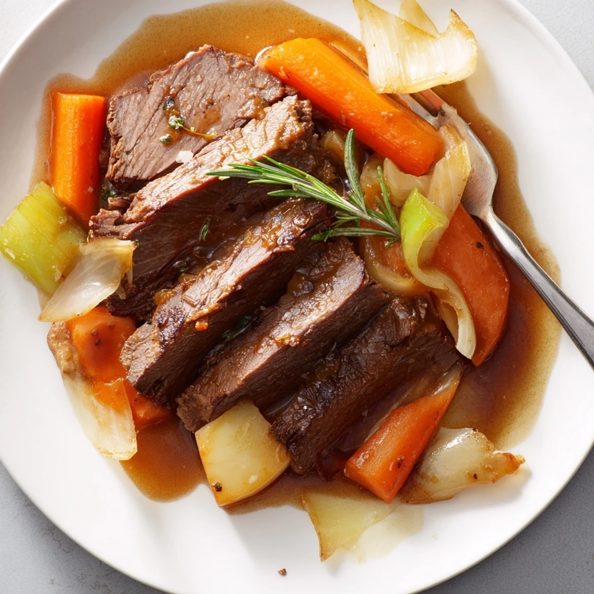 Hearty perfect pot roast surrounded by savory vegetables in a deep, flavorful broth