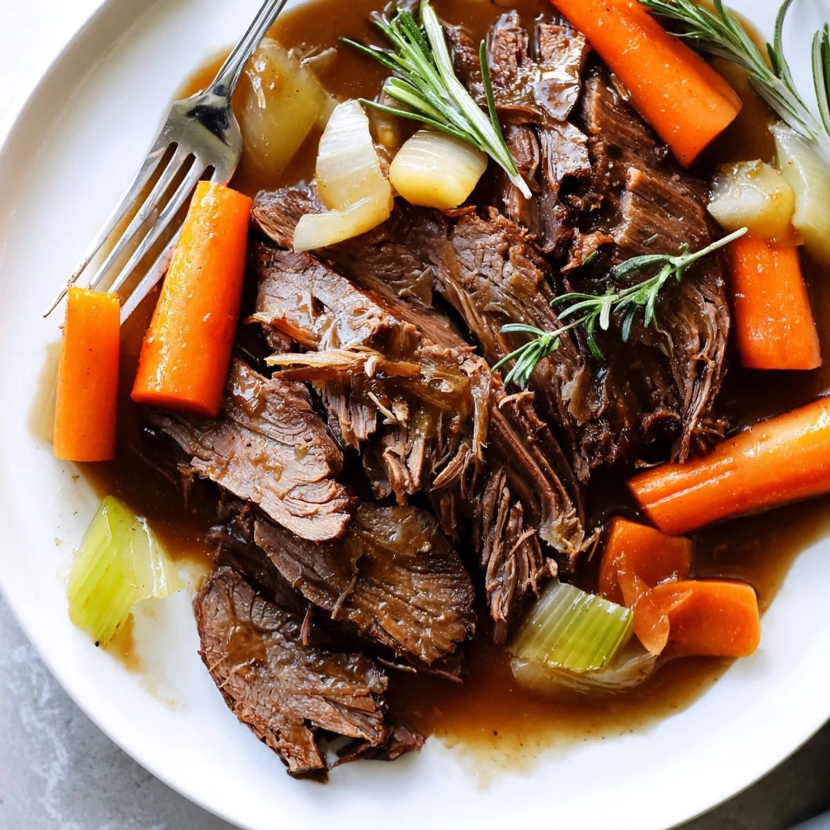 Sliced perfect pot roast drizzled with aromatic gravy alongside soft celery and onion chunks