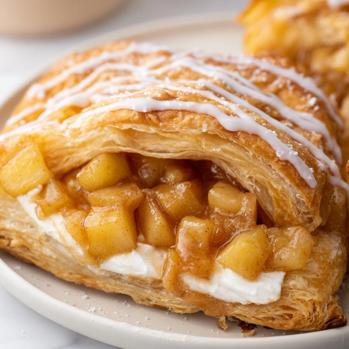Warm apple cheese danishes topped with spiced apples and drizzled vanilla icing