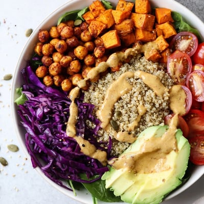 Vibrant Buddha Bowl featuring tender quinoa, fresh avocado slices, and crunchy roasted vegetables